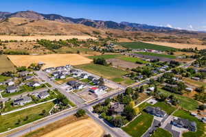 Aerial overview of property's location with nearby suburban area and mountains