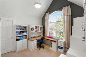 Office area with lofted ceiling