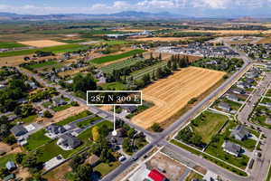 Aerial view of property's location featuring a mountain backdrop and nearby suburban area