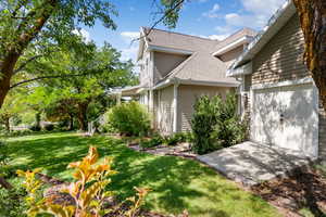View of grassy yard featuring an attached garage