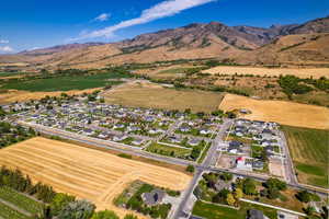 Aerial overview of property's location with nearby suburban area and a mountainous background