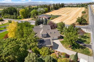 Aerial view of property and surrounding area featuring a mountainous background