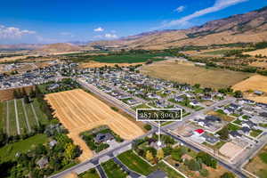 Aerial overview of property's location with nearby suburban area and a mountain backdrop