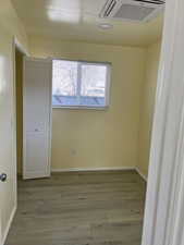 Spare room featuring light wood finished floors and cooling unit