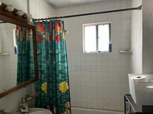 Full bathroom with shower / tub combo with curtain