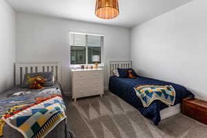 Bedroom featuring carpet floors and a textured ceiling