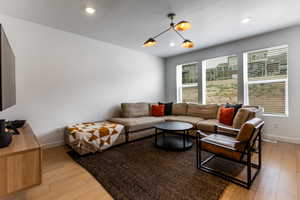 Living area featuring light wood-type flooring, recessed lighting, and a textured ceiling