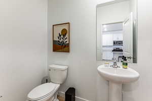 Bathroom with toilet and baseboards