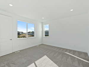 Empty room with carpet floors and recessed lighting