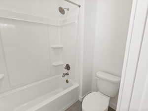 Bathroom with toilet and bathing tub / shower combination