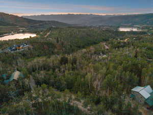 Aerial view at dusk of a water and mountain view and a forest view