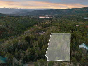 Aerial overview of property's location featuring property boundaries highlighted and a water and mountain view