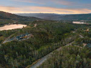View of property location with a water and mountain view and a heavily wooded area