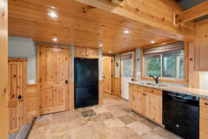 Kitchen featuring light brown cabinetry, black appliances, wood ceiling, recessed lighting, and light stone countertops