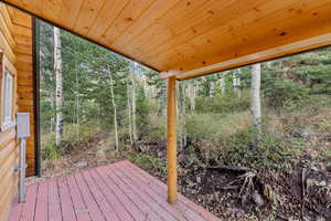 Wooden deck with view of scattered trees