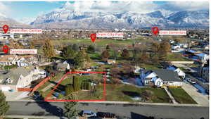 Aerial view of residential area with a mountain backdrop and property boundaries highlighted