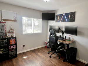 Office space with dark wood-style floors and baseboards