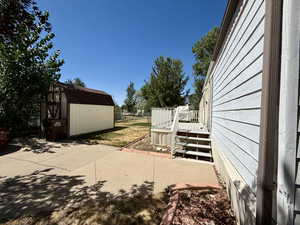 View of patio / terrace with a storage shed and a deck