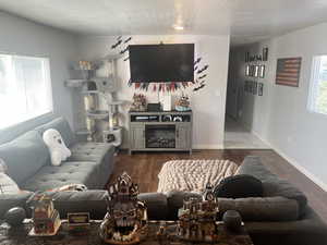 Living area with wood finished floors and baseboards