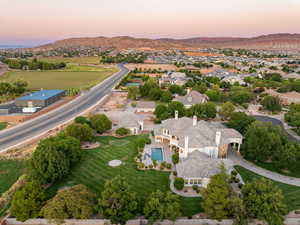 Aerial view at dusk of view of pool area and a mountain view