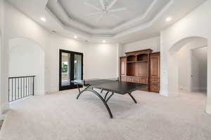 Recreation room featuring light carpet, arched walkways, a ceiling fan, and recessed lighting