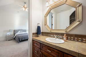 Ensuite bathroom with vanity and ceiling fan