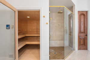 Relaxing sauna / steam room featuring recessed lighting and tile patterned flooring