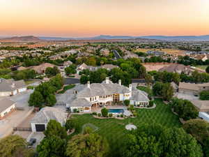 Aerial view at dusk of view of pool and a residential view