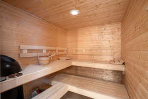 Sauna / steam room with wood ceiling and wooden walls