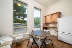 Dining area featuring plenty of natural light and dark tile patterned floors