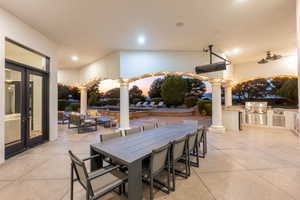 Patio terrace at dusk with area for grilling, a patio area, outdoor dining space, and french doors