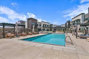 Community pool with a patio