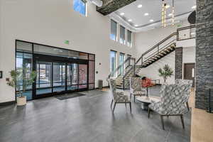 Common area featuring stairway, recessed lighting, a high ceiling, and beamed ceiling
