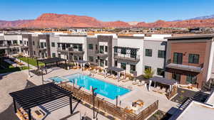 Community pool featuring a mountain view, a residential view, a pergola, and a patio