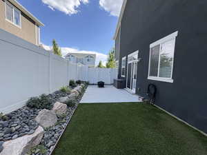 Fenced backyard with a patio area