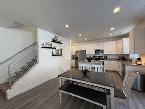 Dining room featuring dark wood finished floors and recessed lighting