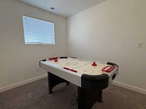 Playroom featuring dark carpet and baseboards
