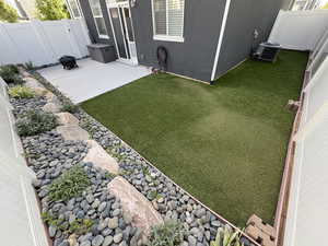 Fenced backyard with a patio area