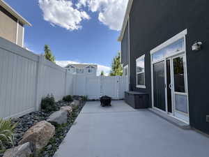 Fenced backyard with a patio and a fire pit