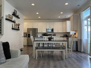 Kitchen featuring appliances with stainless steel finishes, dark wood-style flooring, recessed lighting, and white cabinetry