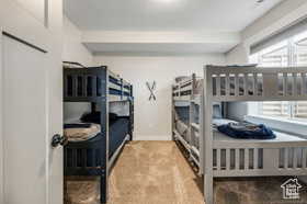Bedroom featuring carpet flooring and baseboards