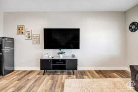 Living area featuring light wood-style flooring and baseboards