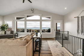 Living area featuring dark wood-type flooring and lofted ceiling