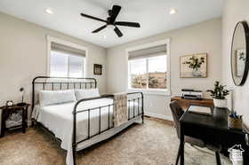 Carpeted bedroom with a ceiling fan, recessed lighting, and a desk