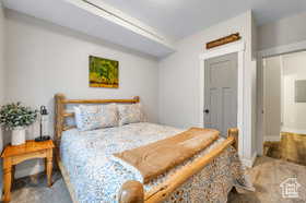 Carpeted bedroom featuring baseboards