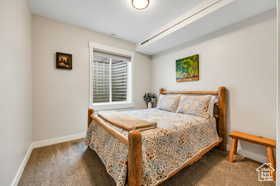 Carpeted bedroom with baseboards