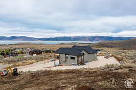 View of front of house with a mountain view and a patio area