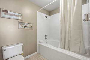 Bathroom with tiled shower / bath combo and tile patterned flooring