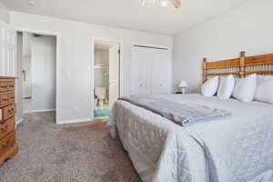 Bedroom with carpet flooring, a closet, ceiling fan, and connected bathroom