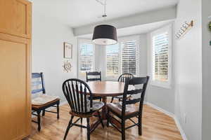 Dining space featuring light wood finished floors and baseboards